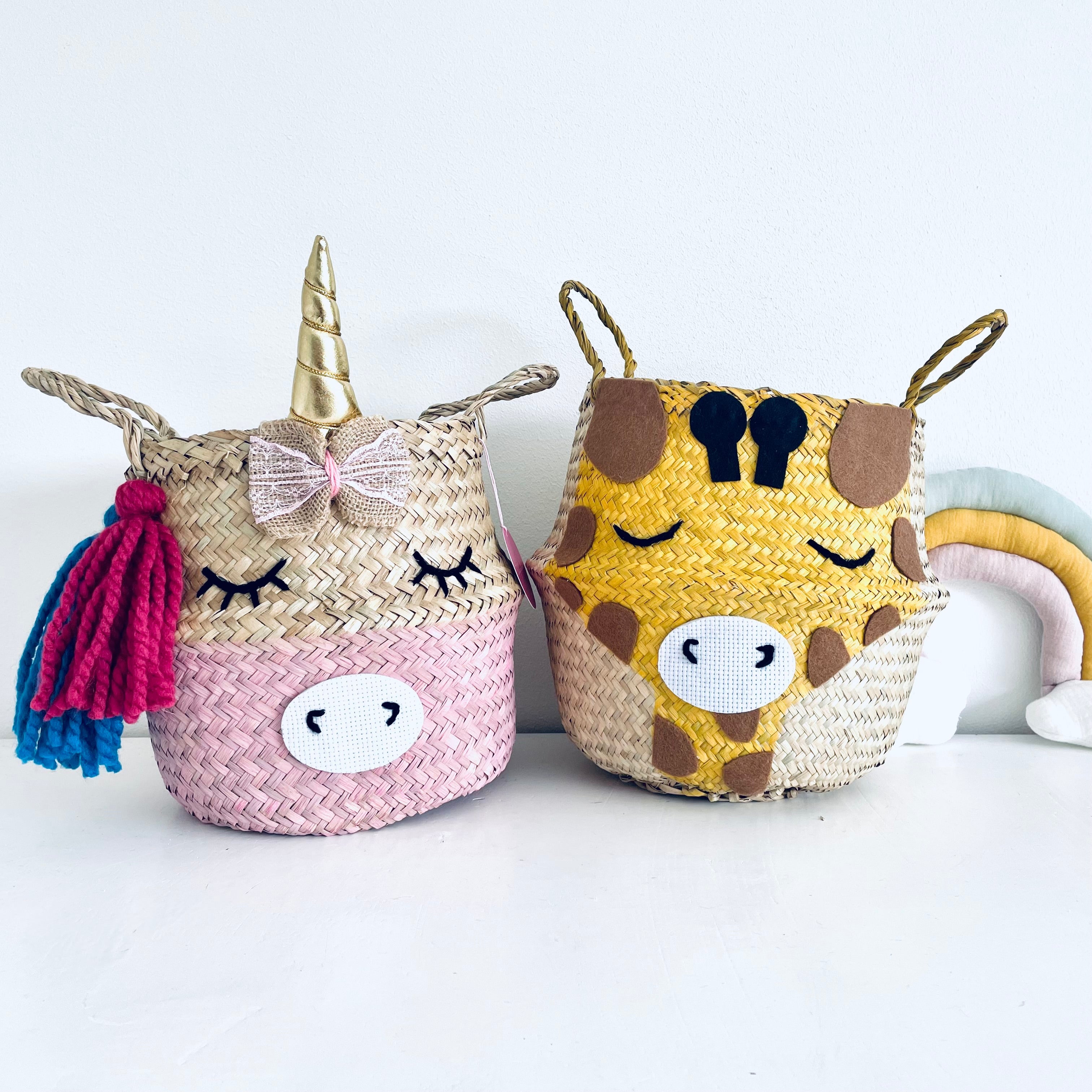 Small unicorn and giraffe storage basket sat on a white work top with rainbow next to it 